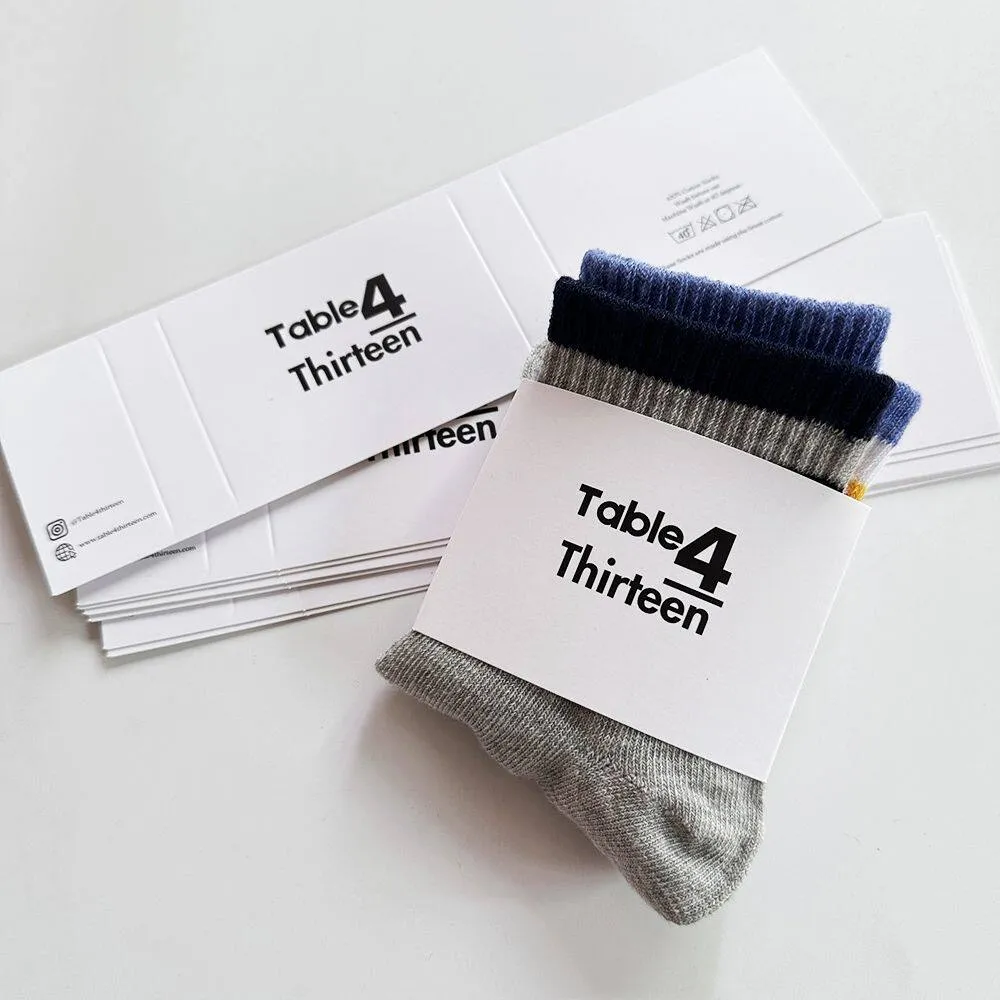 Folded grey socks wrapped with a belly band